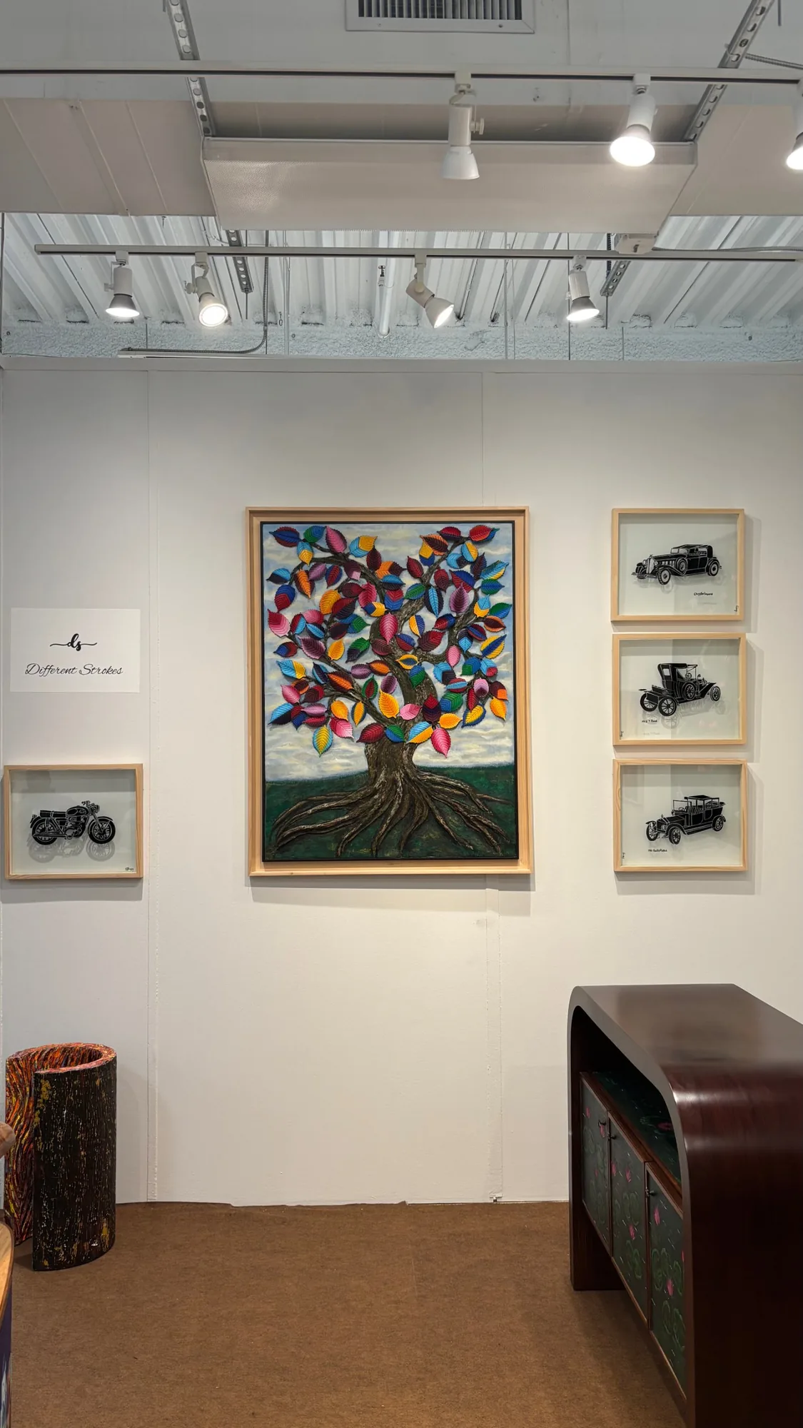 The Divine, a sculptural tree painting, hung between the Vintage Noir glass pieces at the Different Strokes booth